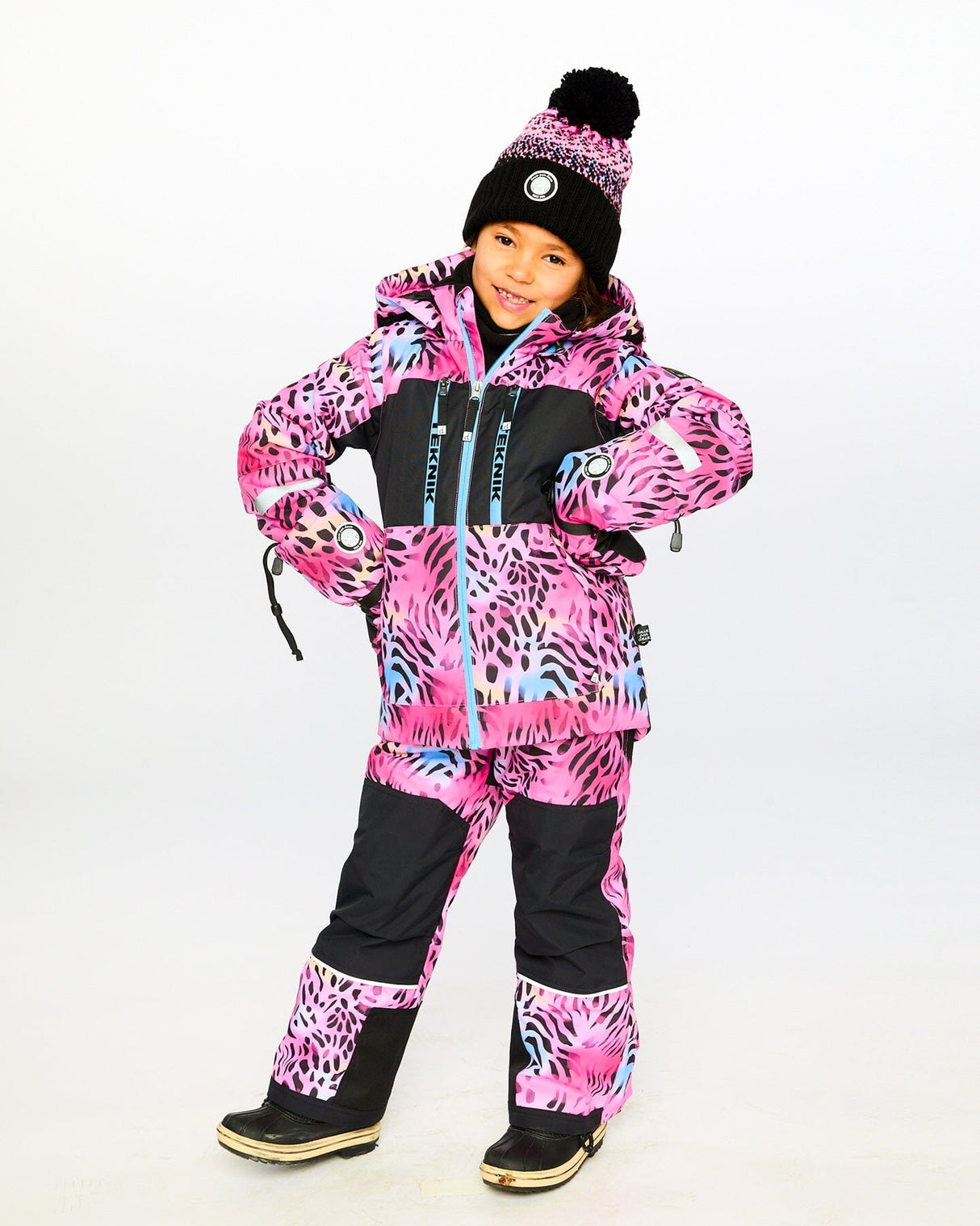 Child wearing Deux par Deux multicolor leopard & zebra snowsuit outdoors – shop now