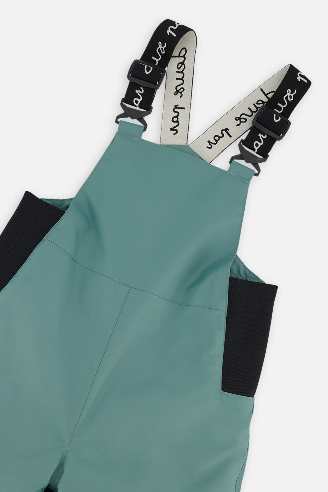 Close-up of the Deux par Deux sage green DISCOVER bib and suspenders
