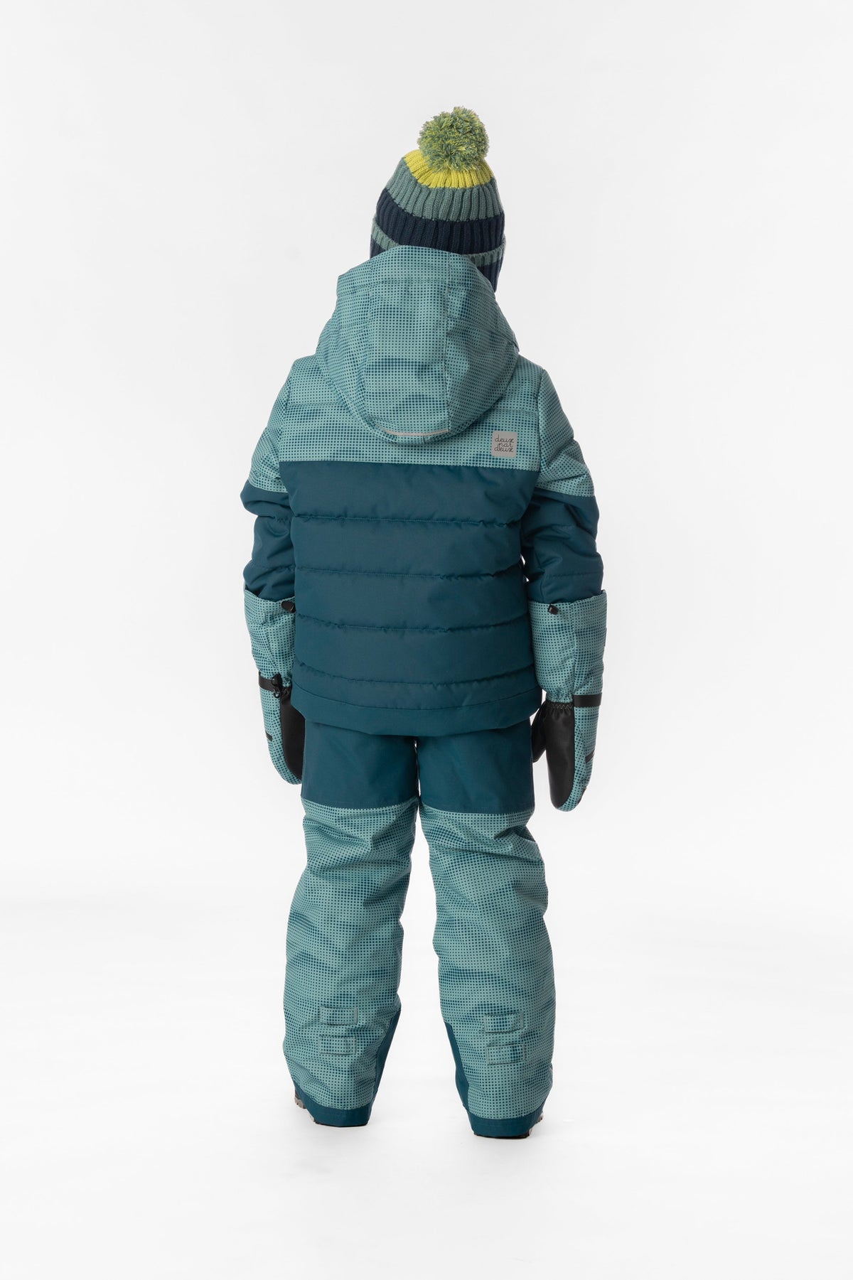 Child wearing the greyish blue and navy Deux par Deux PLAY snowsuit, back view