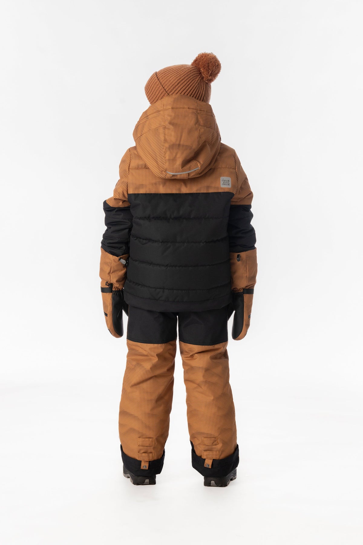 Boy in the brown and black Deux par Deux PLAY snowsuit, back view