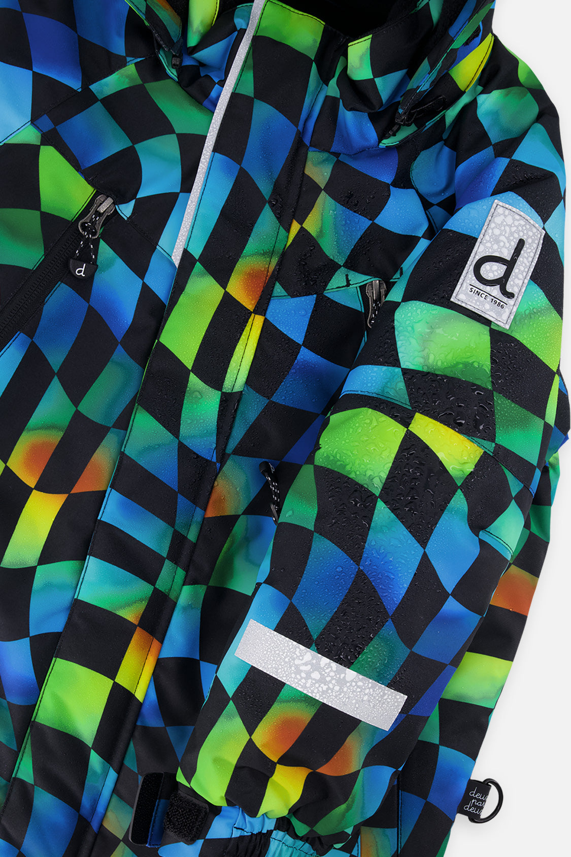 Close-up of the Deux par Deux checkerboard PLAY jacket shell, zipper and sleeve logo patch