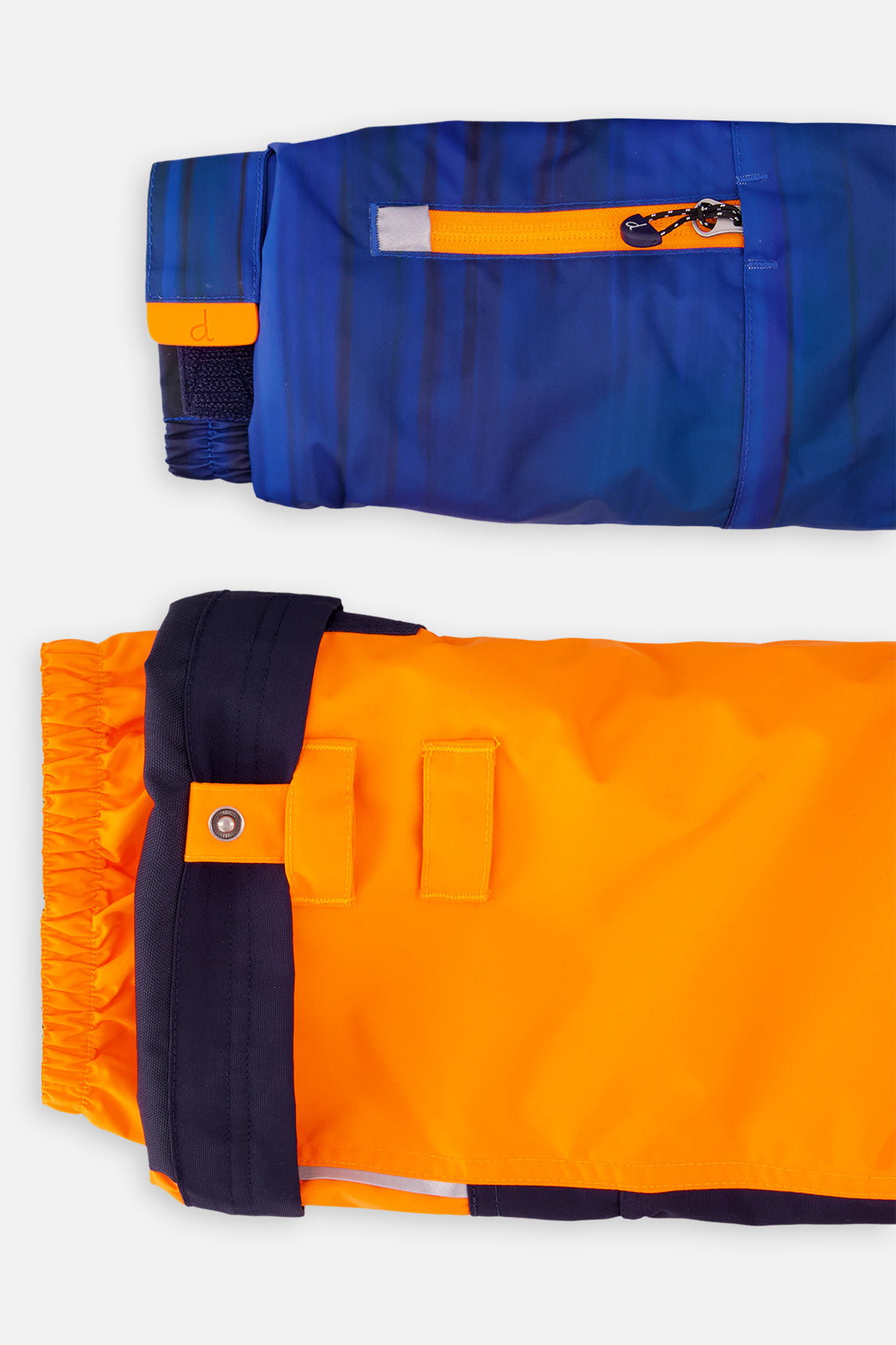 Grow-with-me sleeve extension and adjustable pant hem on the orange and blue snowsuit