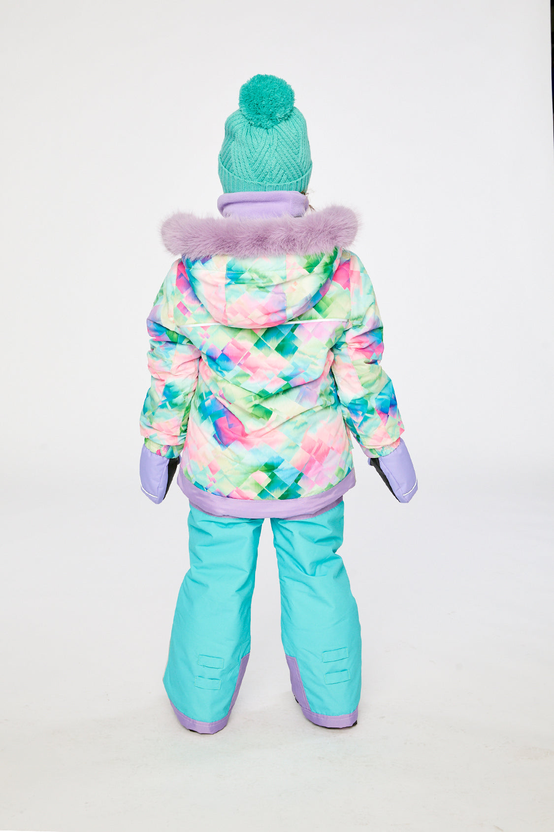 Child in the PLAY snowsuit with diamond-print jacket and turquoise and purple pants, third lookbook shot