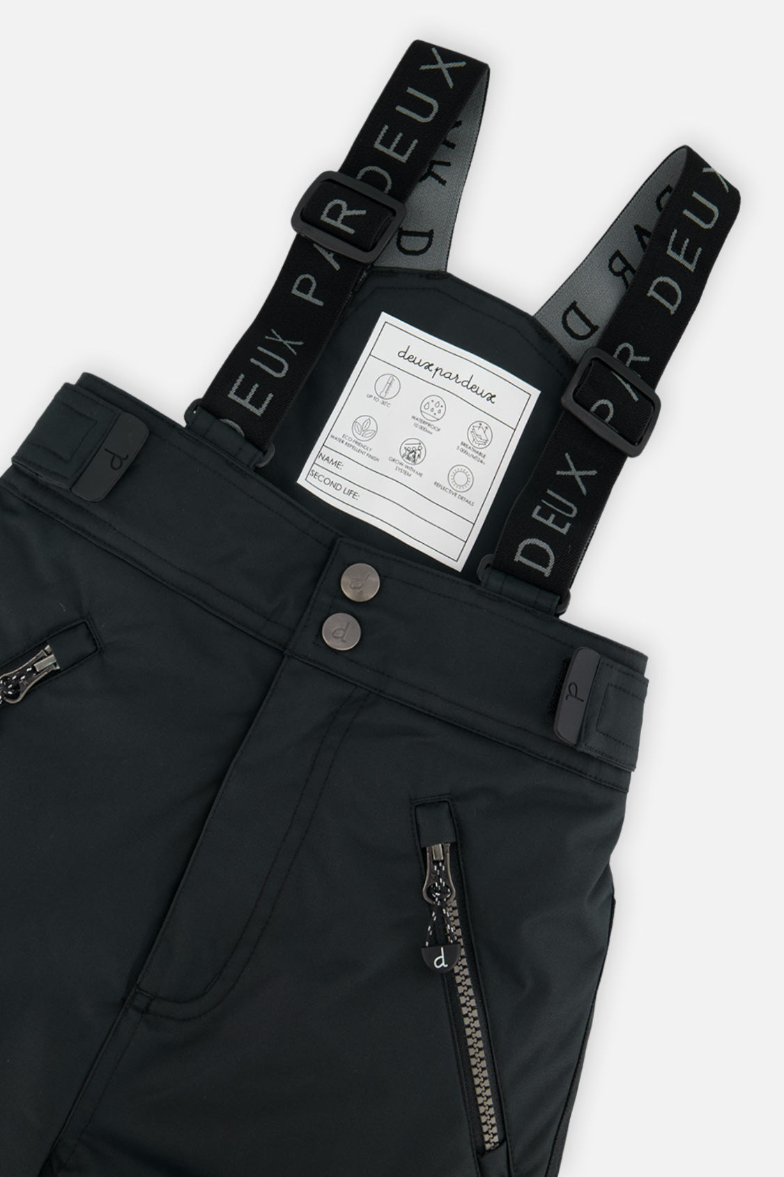 Close-up of the black Deux par Deux PLAY snow pants waist, zippered pockets and suspenders