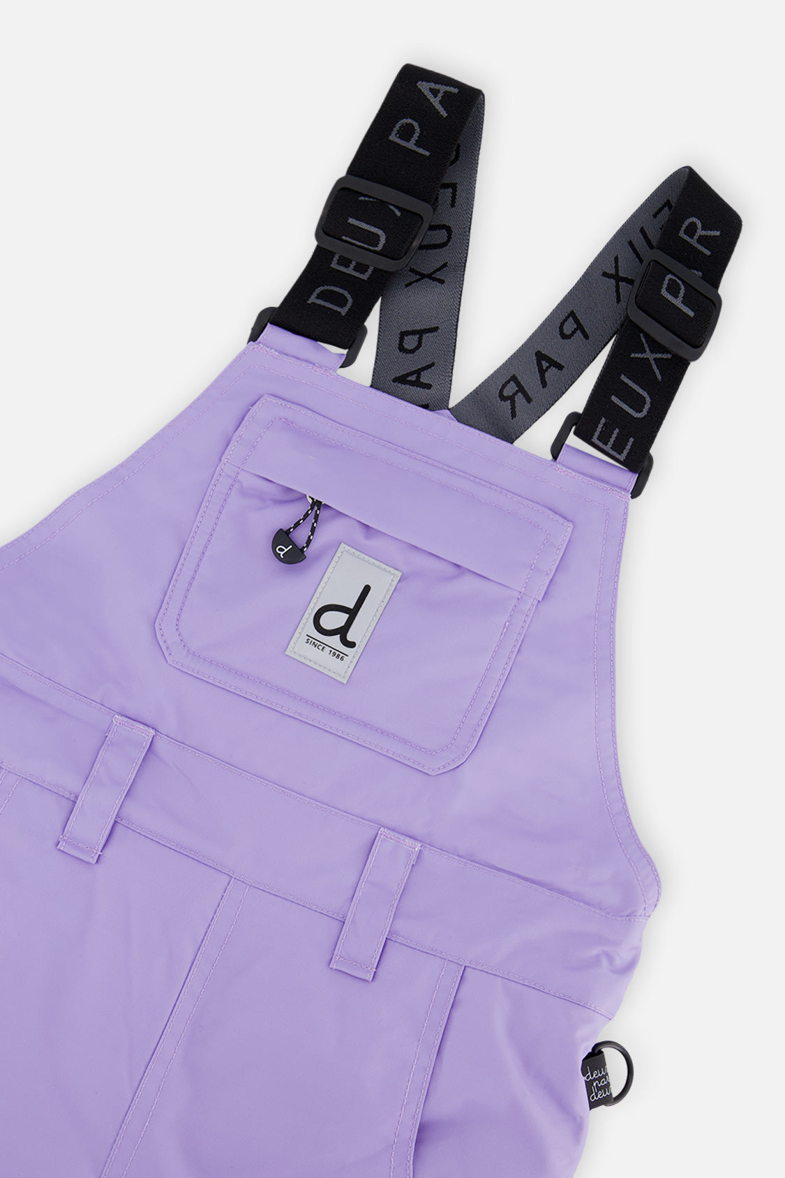 Close-up of the purple PLAY bib chest pocket and logo suspenders