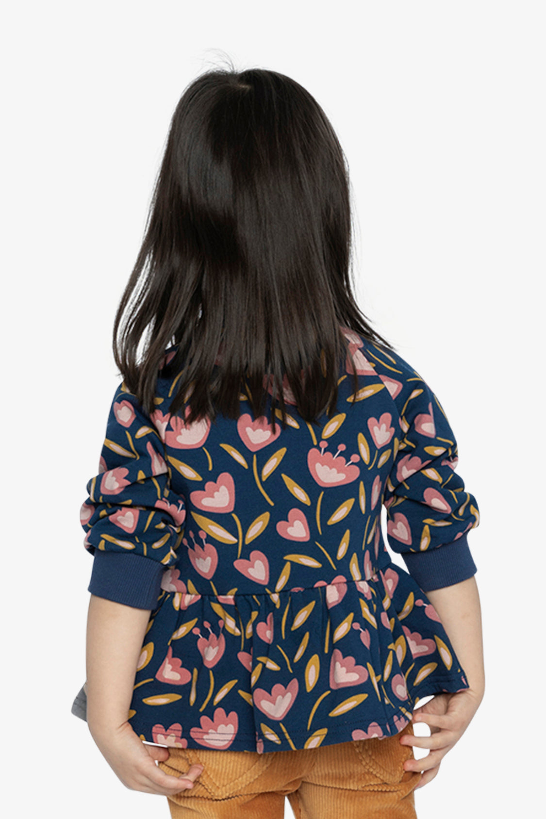 Child wearing the deep blue tulip print peplum top, back view