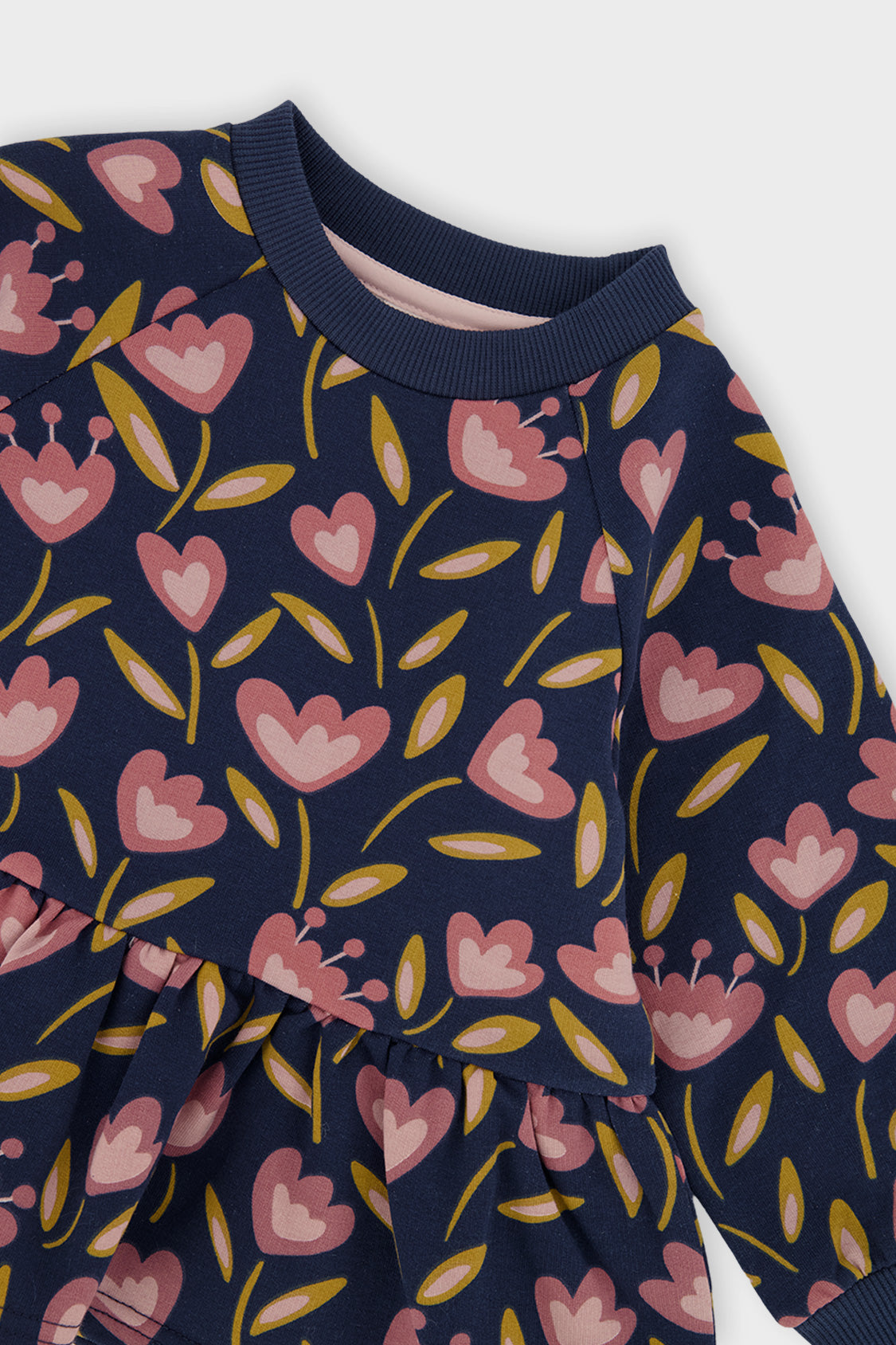 Close-up of the ribbed collar and the pink tulips on the deep blue Deux par Deux peplum top