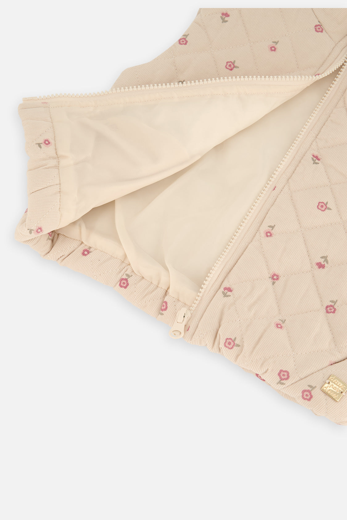 Inside view of the cream quilted Deux par Deux vest with the zipper open