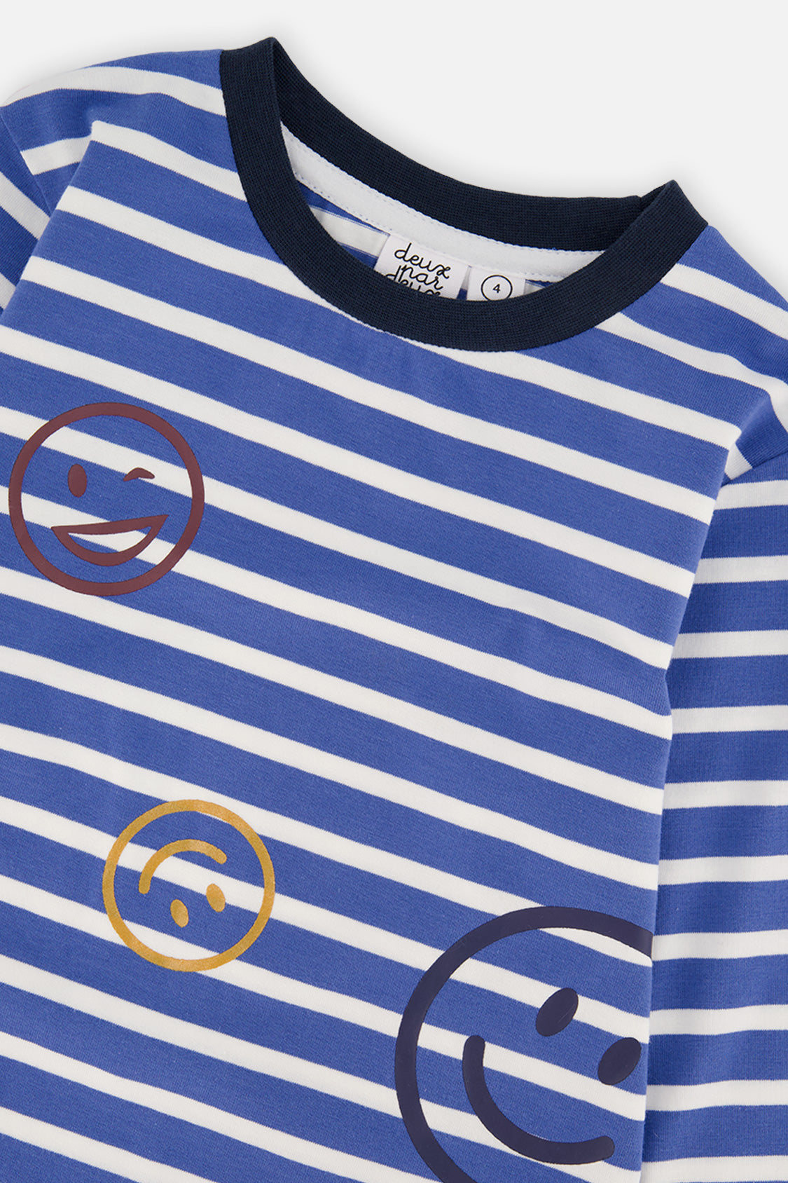 Close-up of the smiley faces and navy collar on the striped t-shirt
