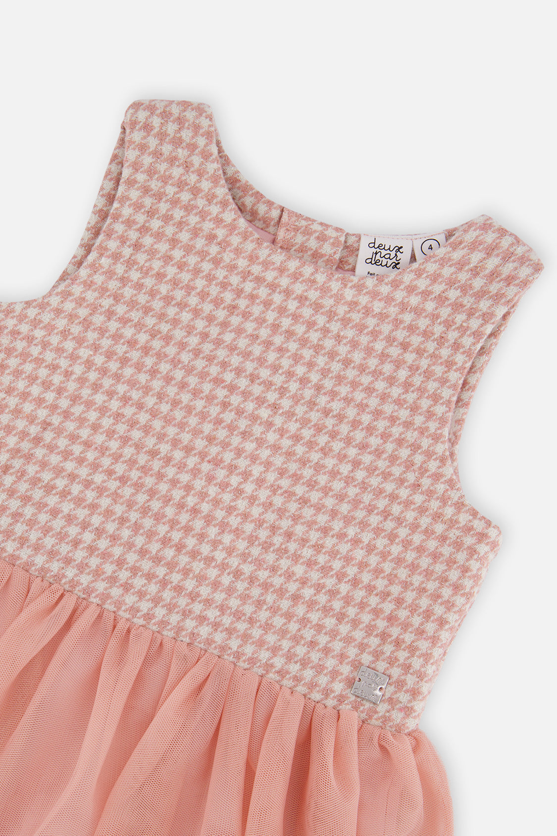 Close-up of the pink and white houndstooth jacquard bodice and mesh skirt seam