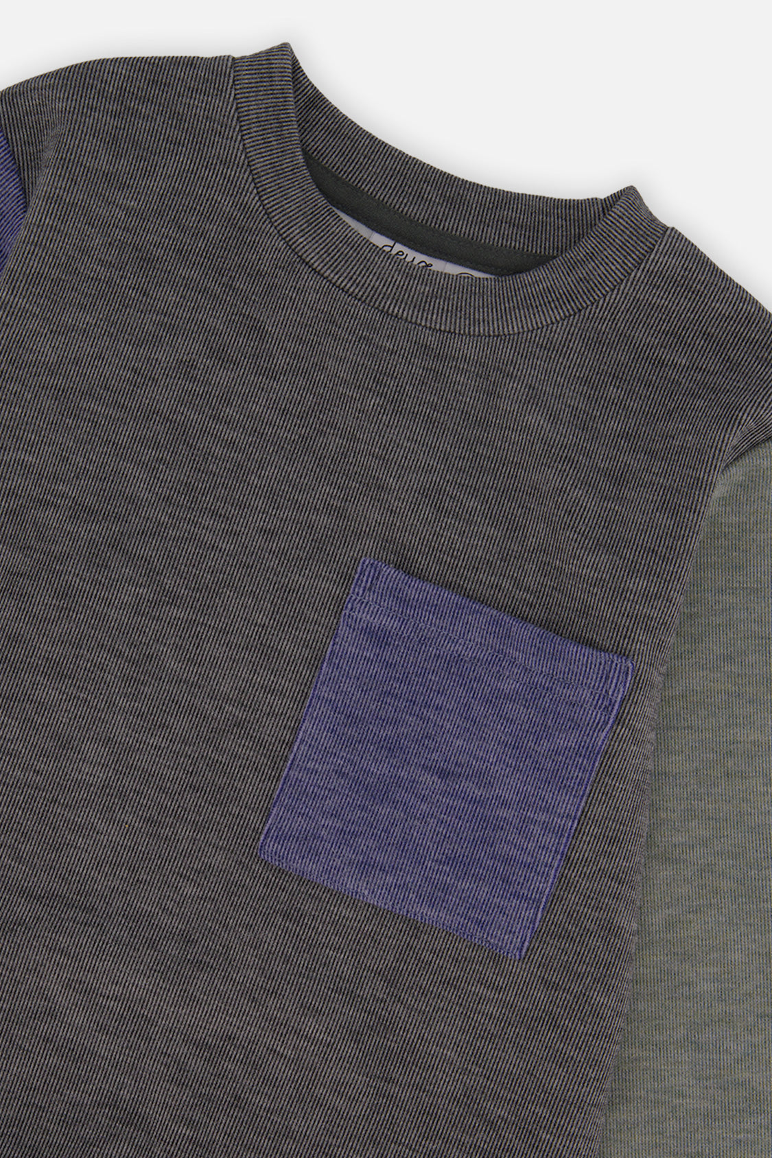 Close-up of the ribbed crew neck and blue patch pocket on the charcoal knit