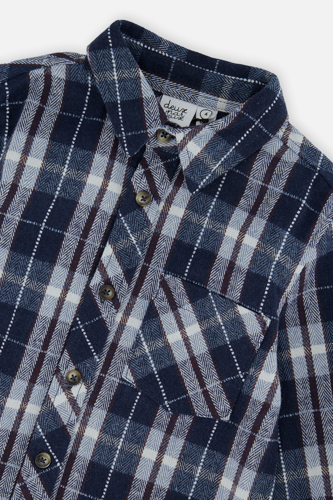 Close-up of the collar, buttons and chest patch pocket on the blue and white plaid flannel shirt