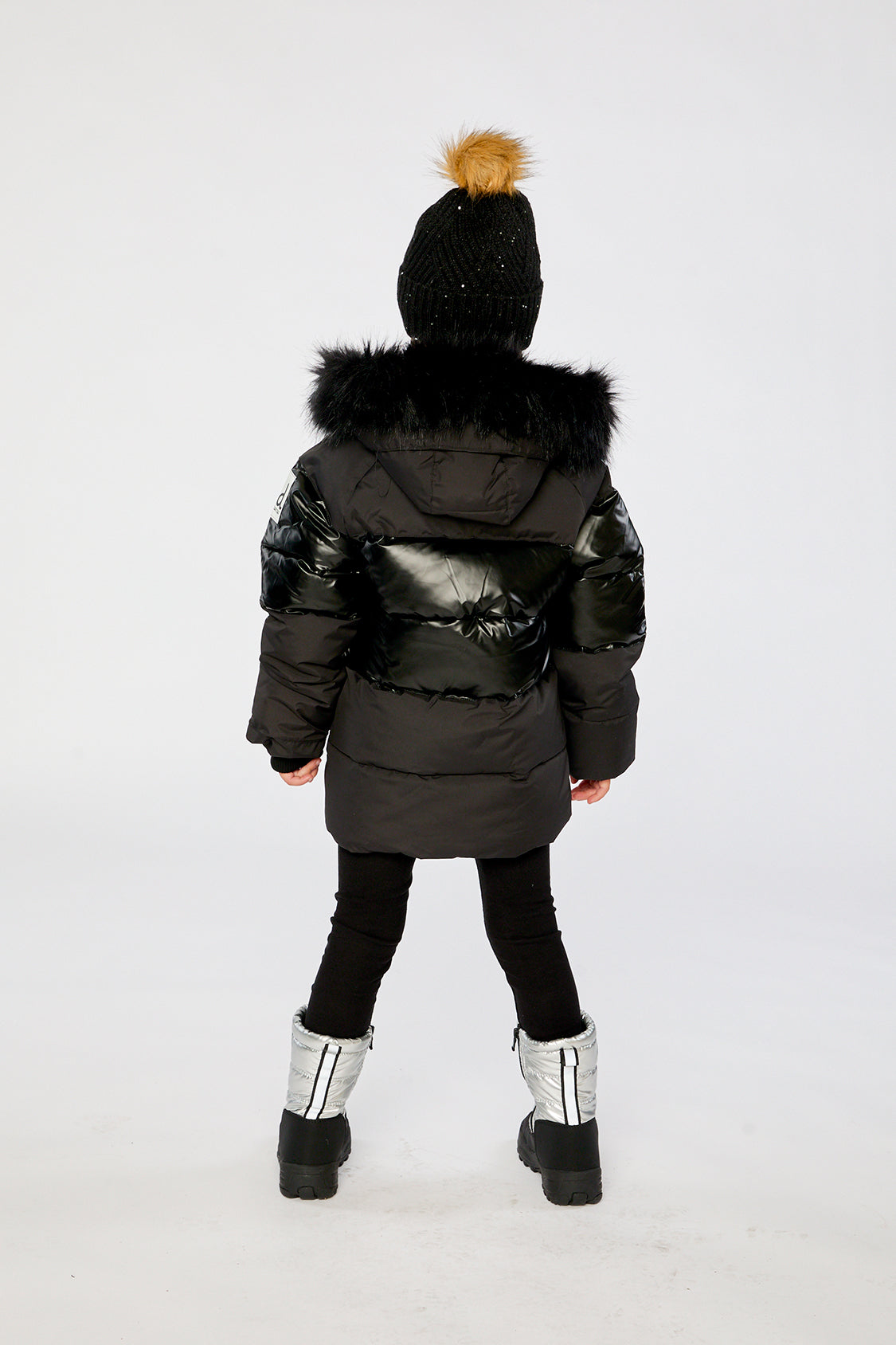 Child wearing the Deux par Deux black winter jacket with chest pattern, view 3