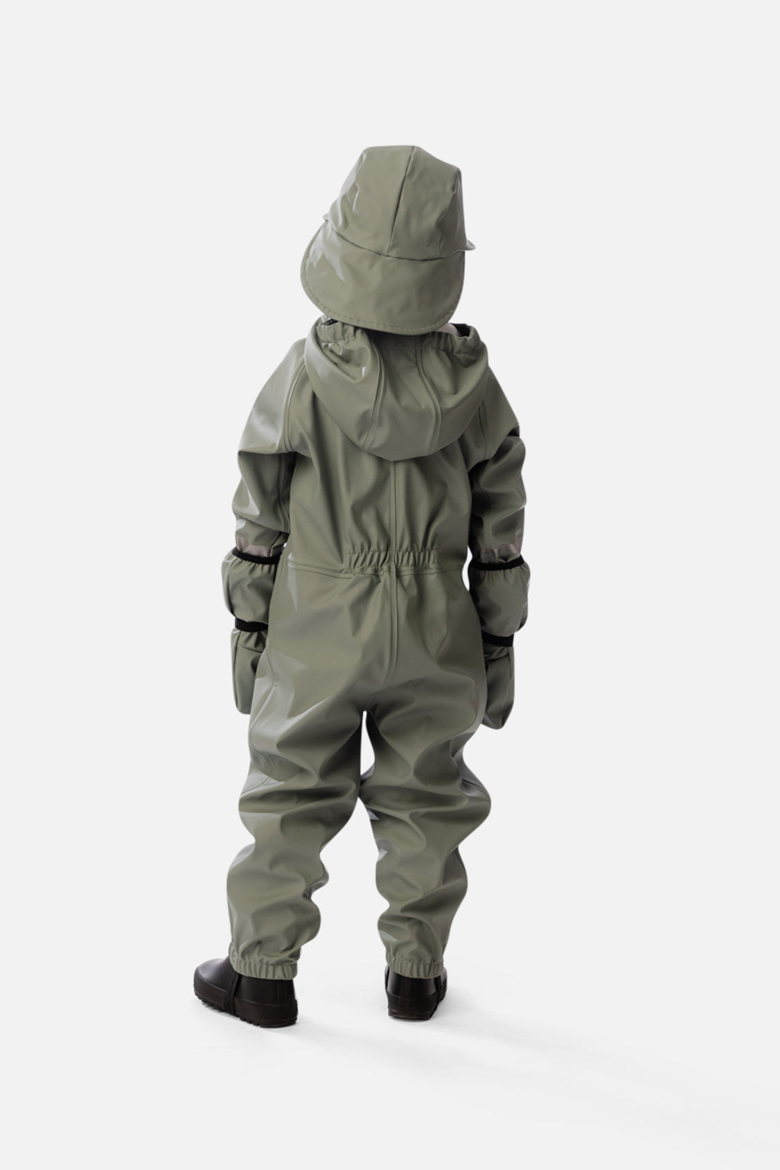 Back view of a child wearing the sage green rain one-piece with mittens and a rain hat