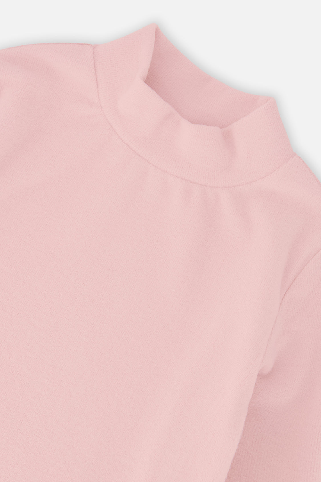 Close-up of the mock neck and rib knit on the pale dusty pink top