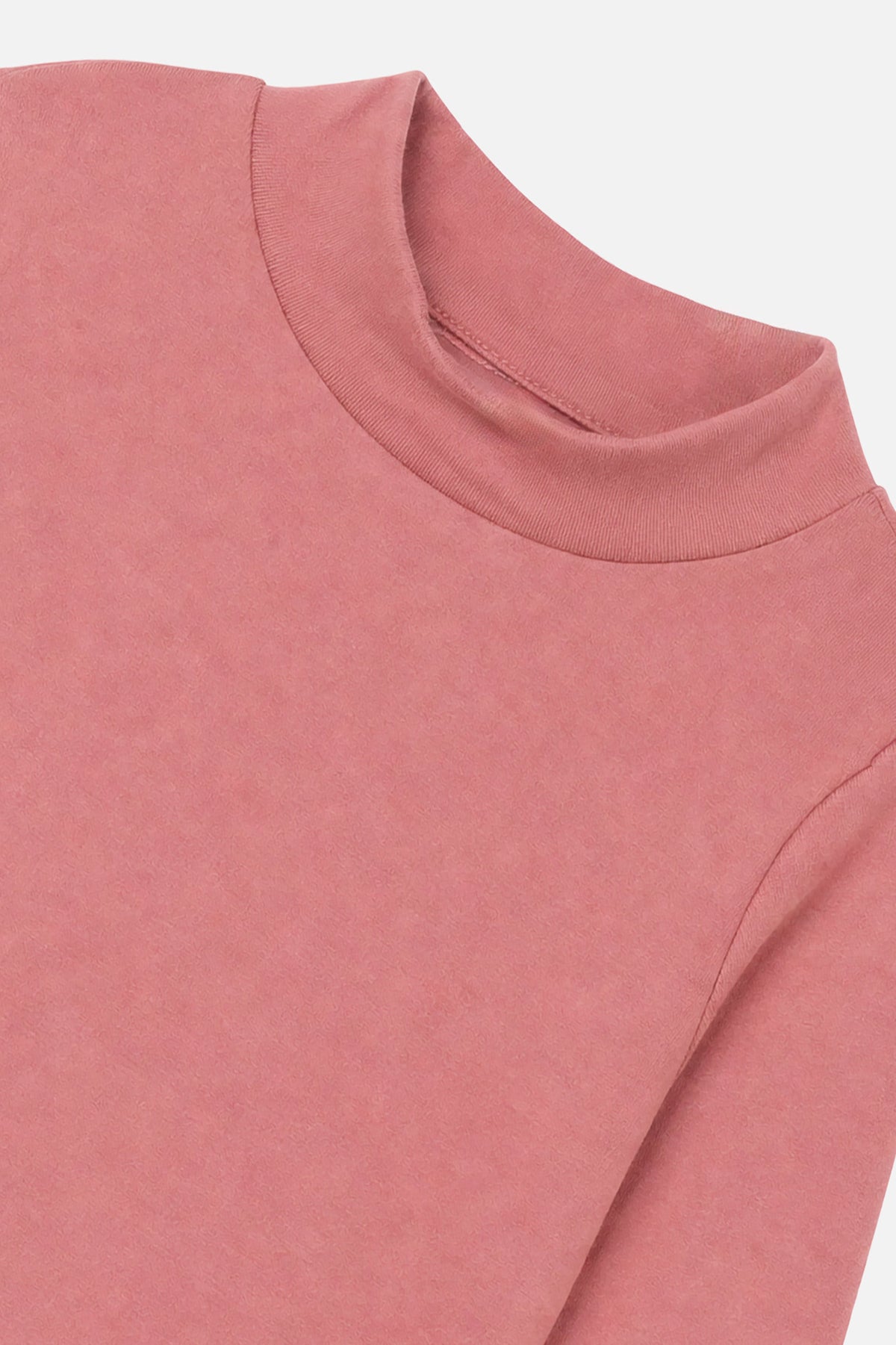 Close-up of the mock neck collar and brushed rib on the pink top
