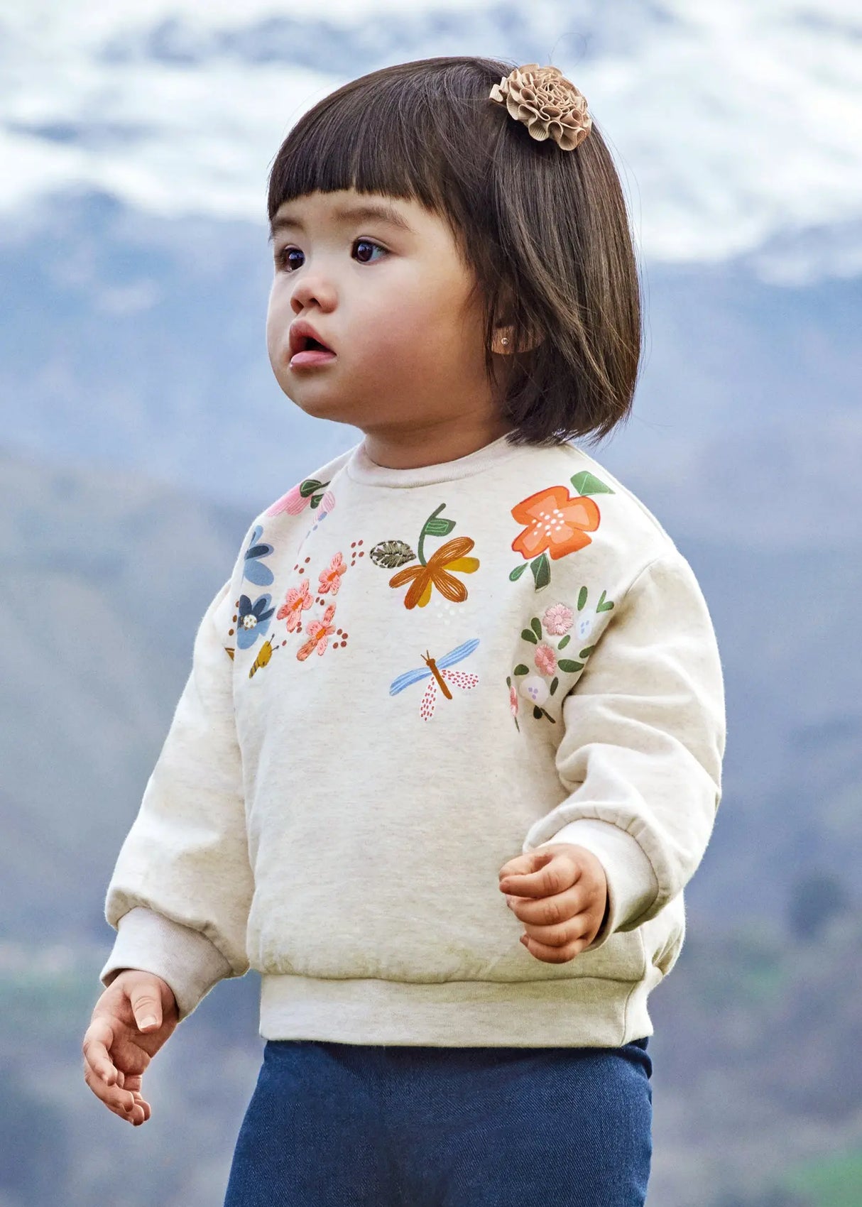 Baby girl wearing Mayoral Lino embroidered sweatshirt for a soft everyday outfit.