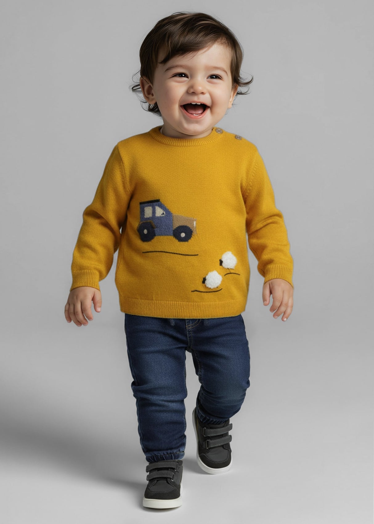 Lifestyle image of baby boy wearing dark denim infant denim joggers with drawstring waist.