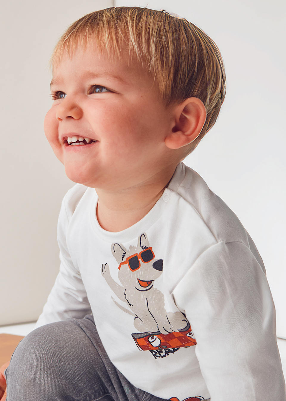 Toddler side view showing relaxed fit and soft cotton jersey.