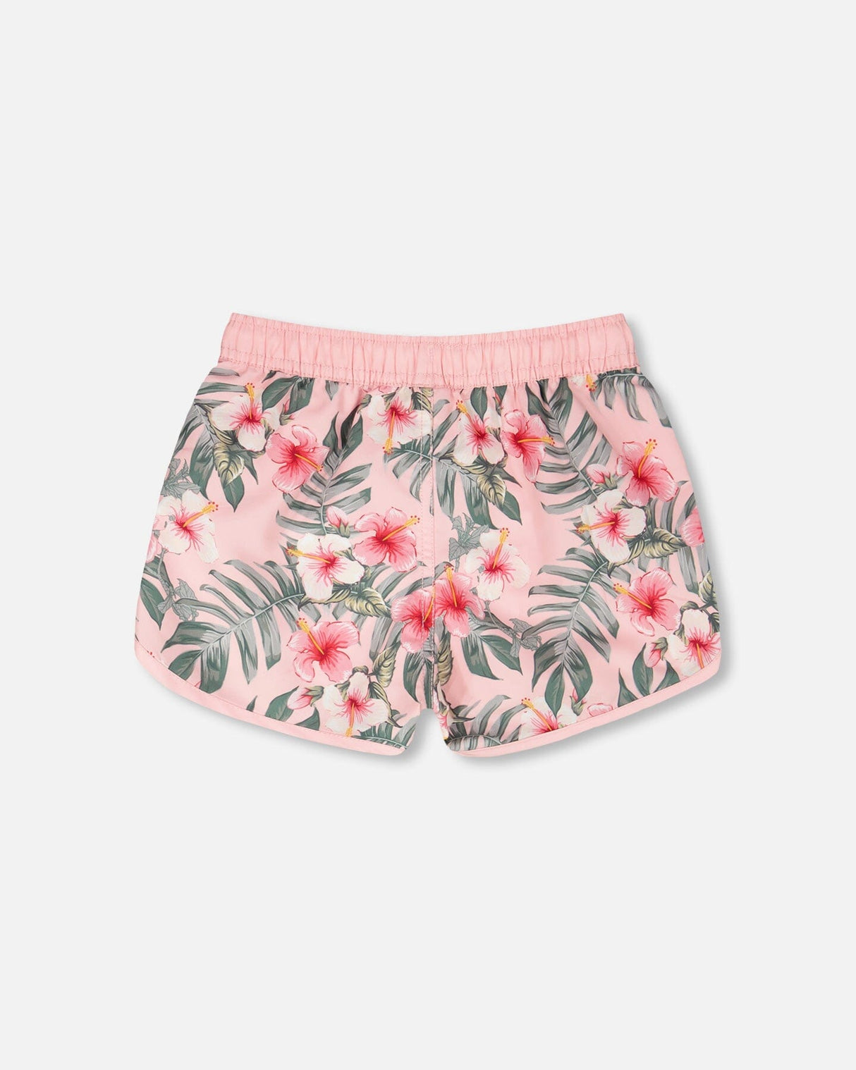Side view of pink hibiscus boardshorts for girls showing curved hem and waistband