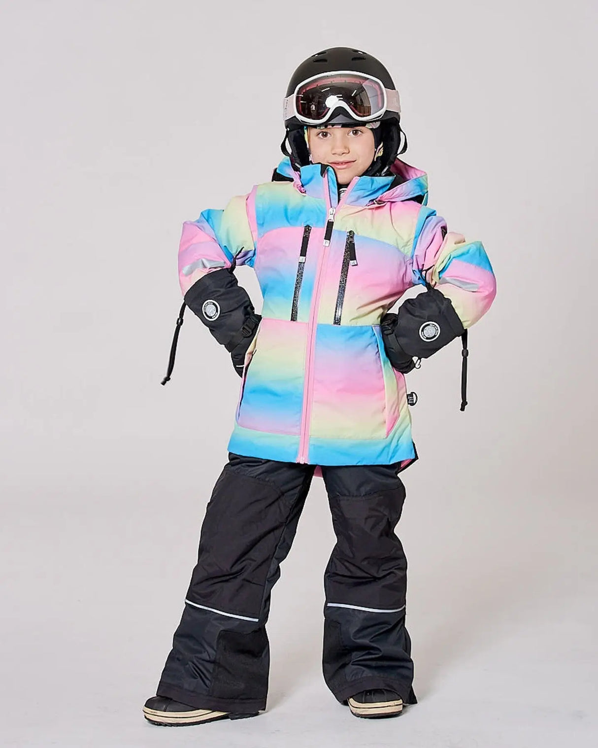 Girl wearing TEKNIK rainbow snowsuit outdoors in winter scene
