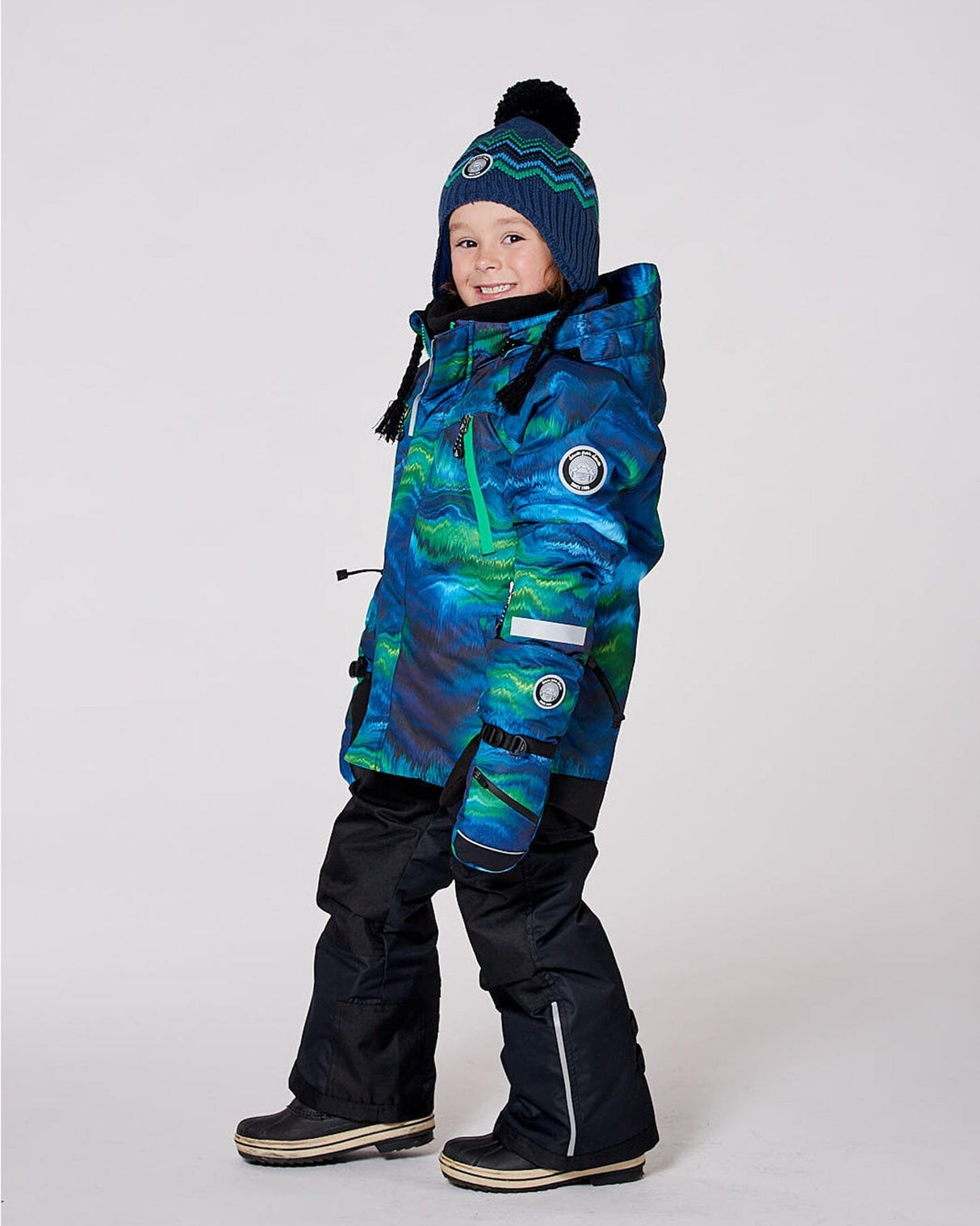 Two-piece ski suit on model, printed jacket with hood