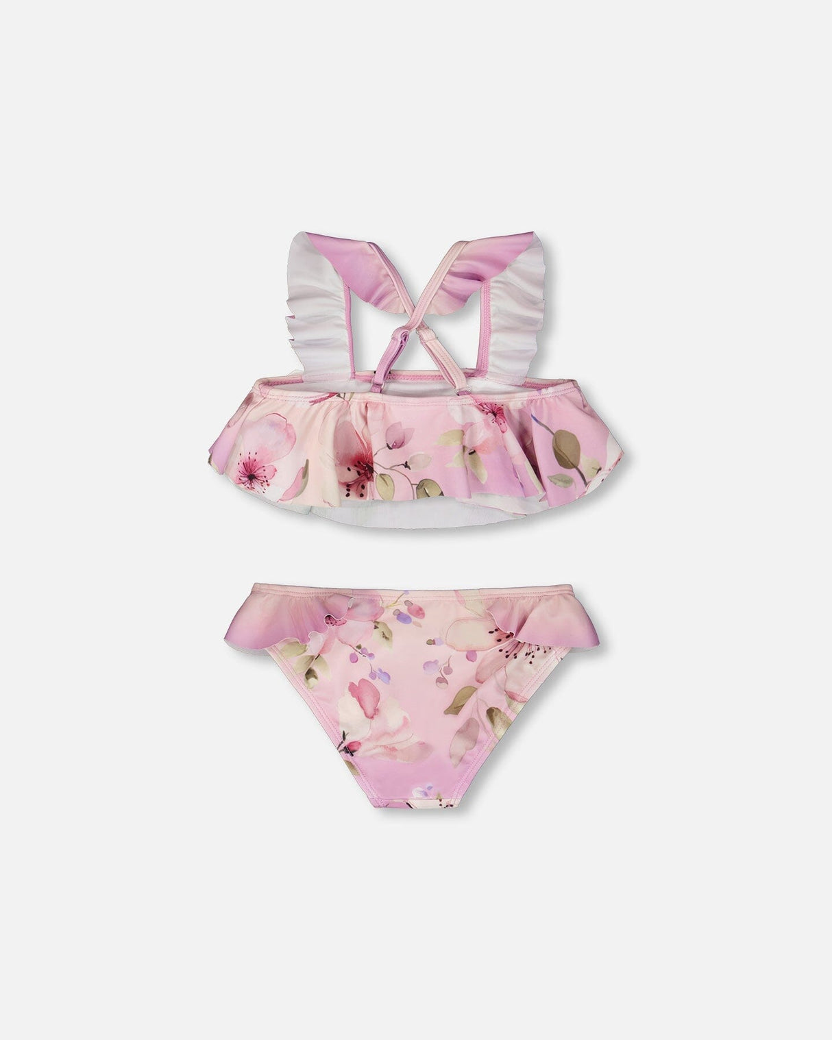 Detail shot of ruffled straps and floral print on purple girl two-piece swimsuit