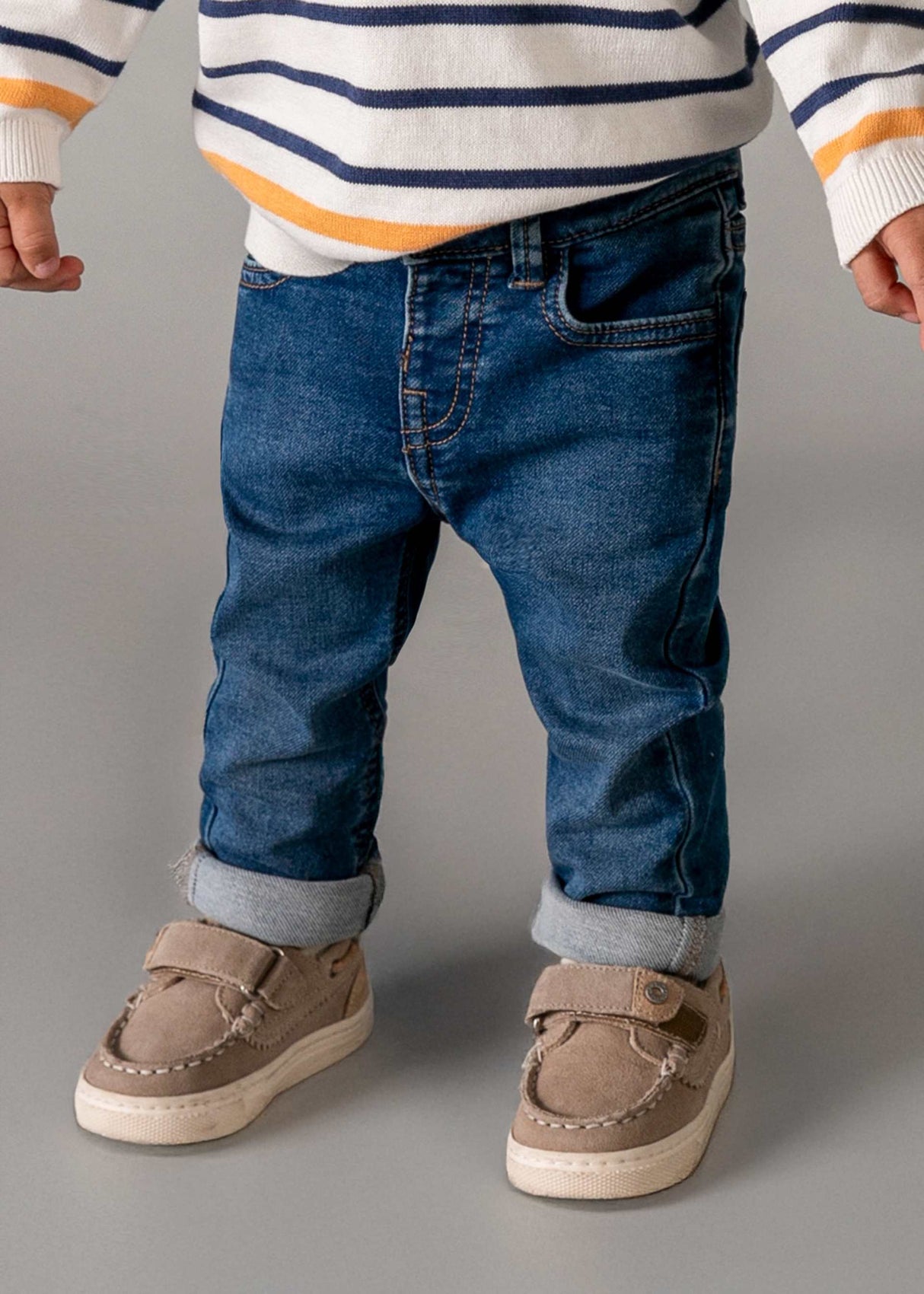 Baby boy wearing Mayoral Light Blue slim fit jeans with casual shoes and everyday outfit.
