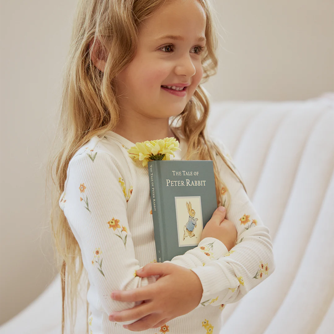 Child in daffodil print long-sleeve pajama set with elastic-waist pants