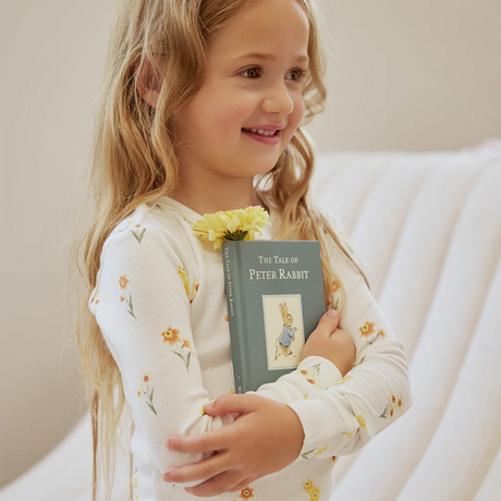 Child in daffodil print long-sleeve pajama set with elastic-waist pants