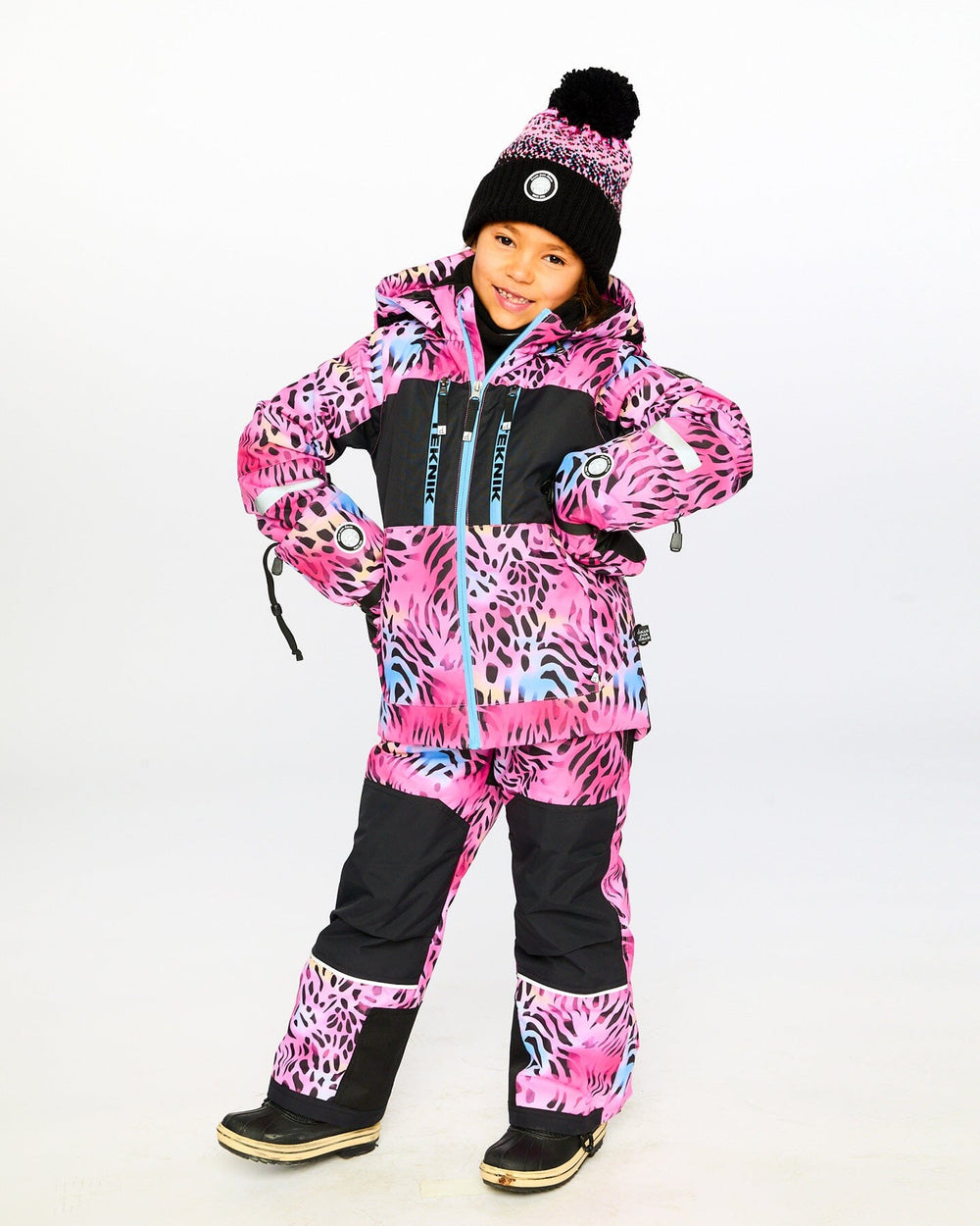 Child wearing Deux par Deux multicolor leopard & zebra snowsuit outdoors – shop now