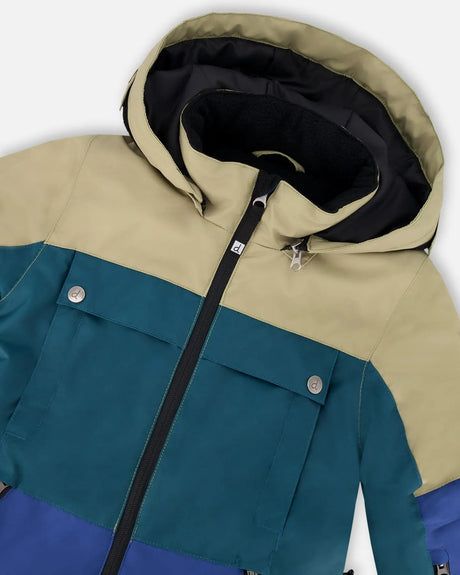 Close-up of detachable hood and trim detail on Teknik snowsuit colorblocked navy