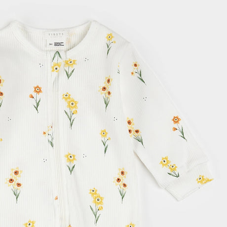 Close-up of yellow daffodil floral print and two-way zipper on organic cotton baby sleeper