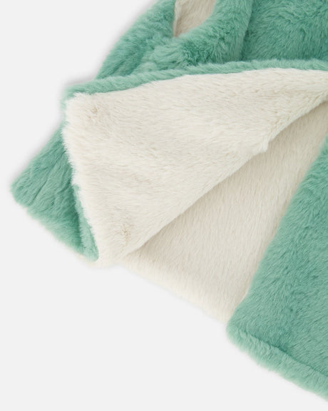 Folded edge showing the off-white plush lining the sage green side of the faux fur vest