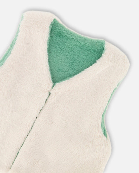 Close-up of the off-white plush front with the sage green side showing at the neckline