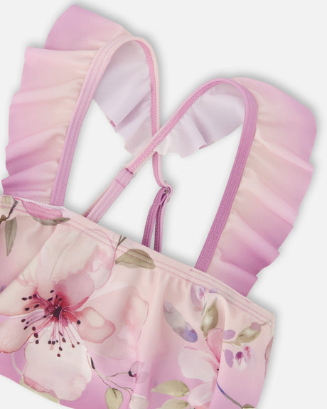 Close-up of the crossed ruffled straps on the purple flower swim top