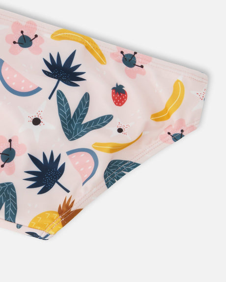 Close-up of bananas, a strawberry, watermelon and palm leaves on the swim bottoms