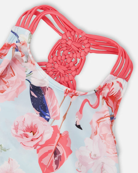 Close-up of the pink macramé straps and the rose and flamingo print on the swimsuit top