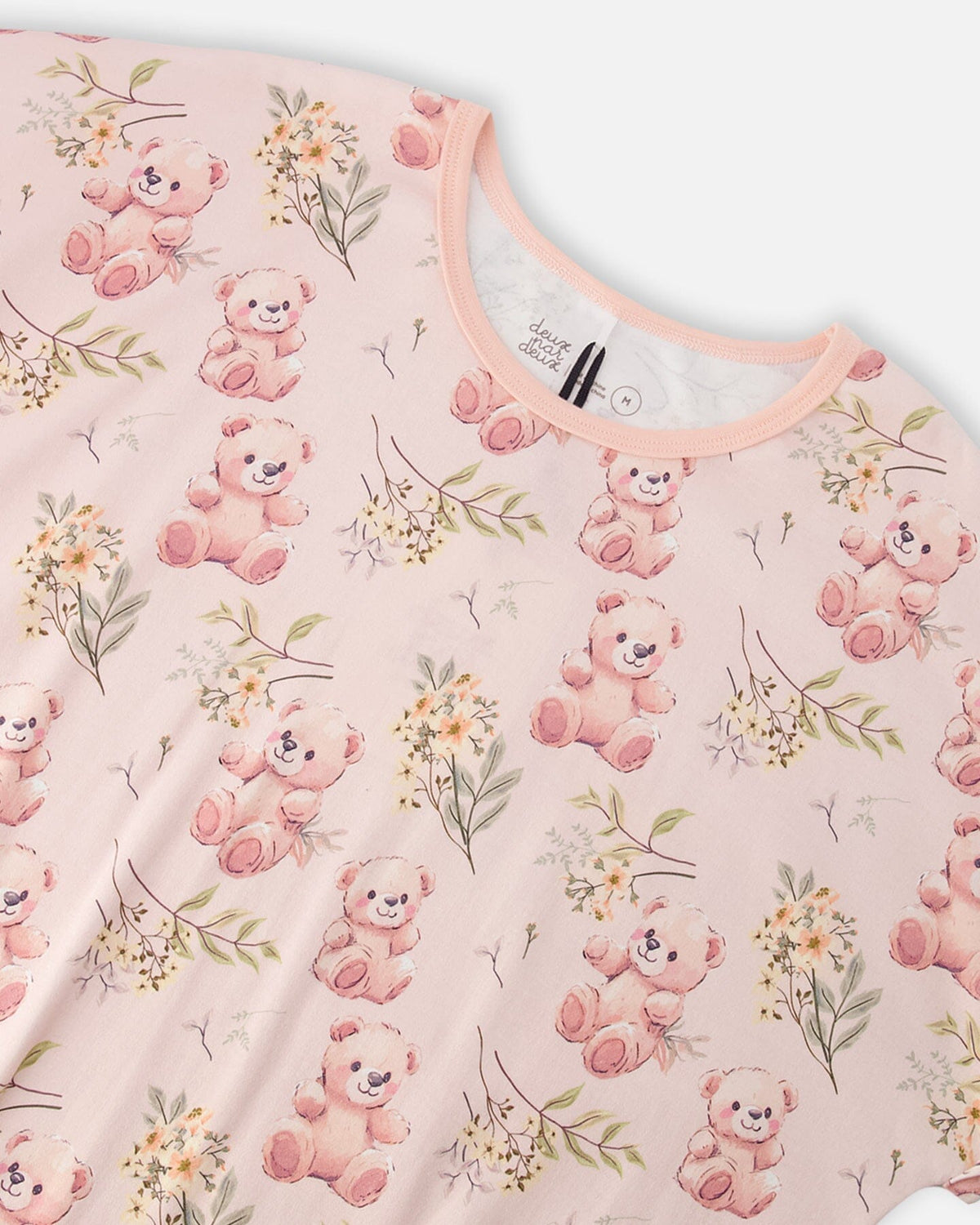 Close-up of the peach trimmed crew neck and teddy bear print on the PJ top