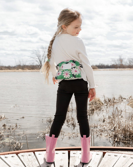 Girl seen from behind wearing the windbreaker packed into its pouch around her waist