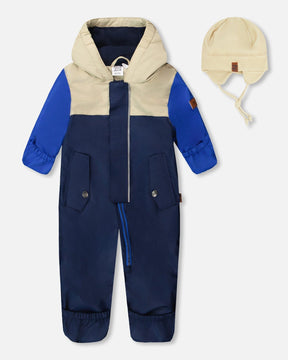 Deux par Deux baby boy mid-season one-piece with hat in navy blue, front view