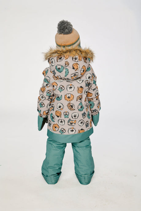 Child wearing the Deux par Deux DISCOVER snowsuit, beige with dog print, lookbook view