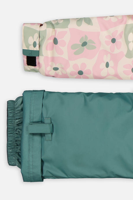 Close-up of the retro pink print DISCOVER jacket cuff and the adjustable sage green pant hem