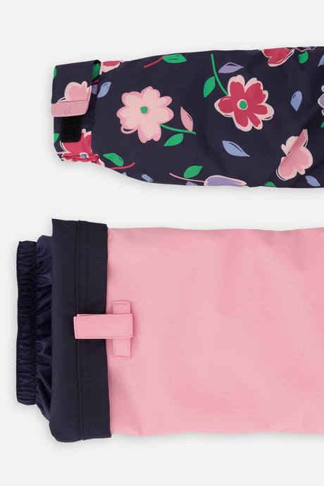 Close-up of the navy floral DISCOVER jacket cuff and the adjustable pink pant hem