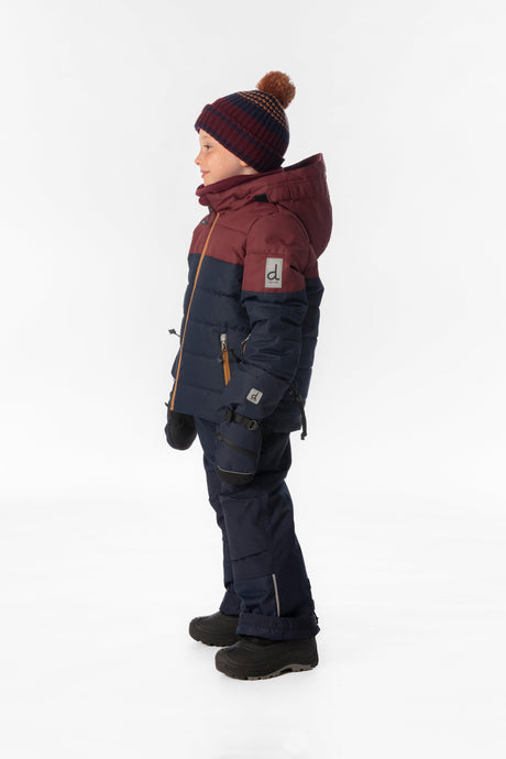 Boy in the navy and burgundy Deux par Deux PLAY snowsuit, side view