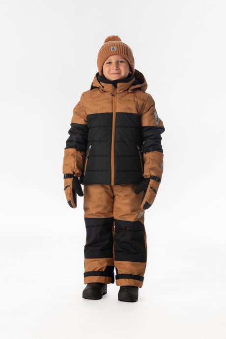 Boy standing in the brown and black Deux par Deux PLAY snowsuit, full-length front view