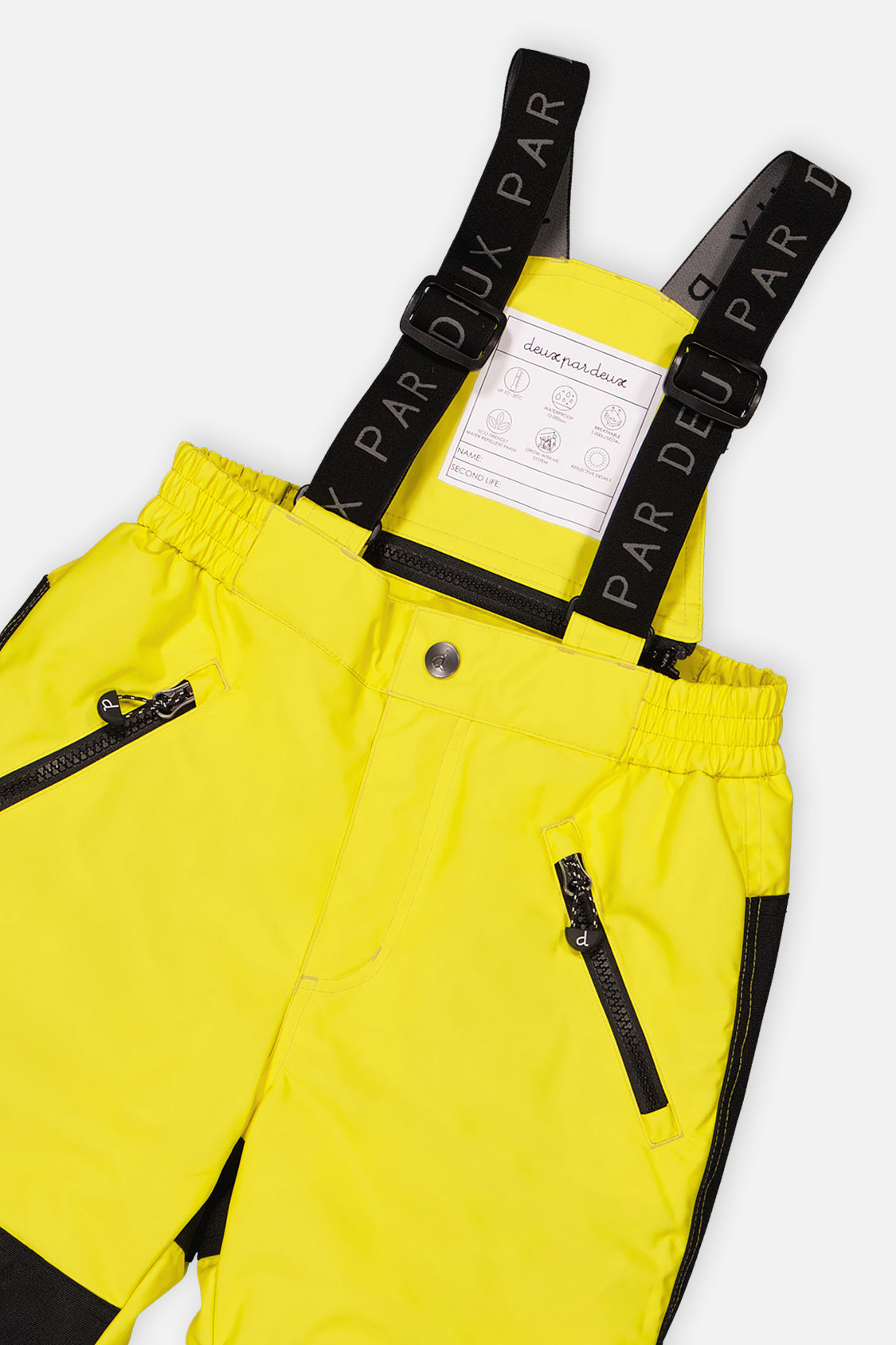 Close-up of the Deux par Deux yellow PLAY snow pants waist, zippered pockets and suspenders