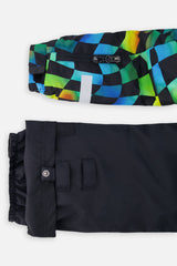 Close-up of the checkerboard PLAY jacket ski-pass sleeve pocket and black pant hem