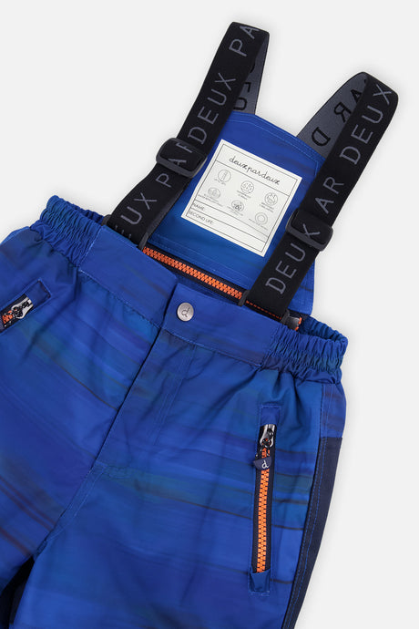 Close-up of the blue snow pants suspenders and zippered pocket