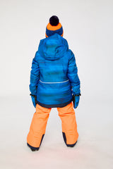 Back view of a boy wearing the blue jacket and orange snow pants